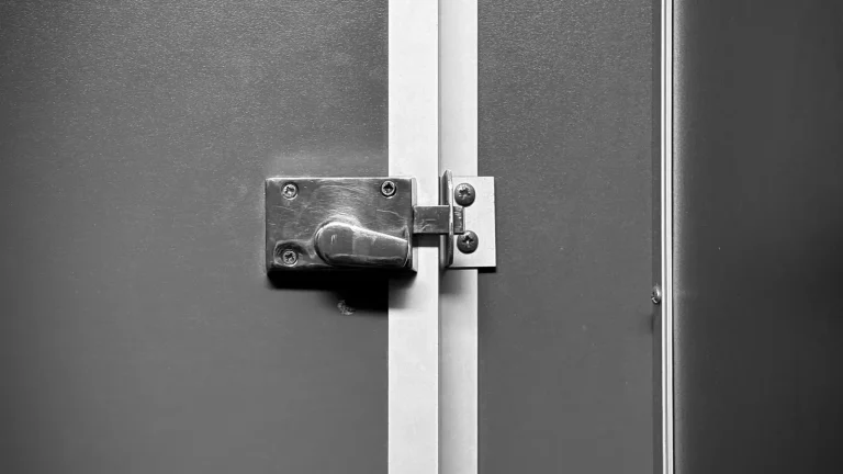 Sliding bolt lock on a grey door, lock installation in Anderson, SC