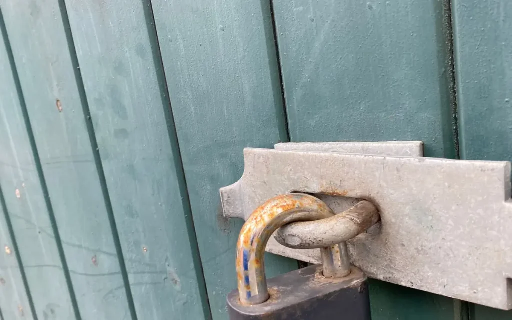 Padlock on a teal gate, lock service in Pendleton, SC