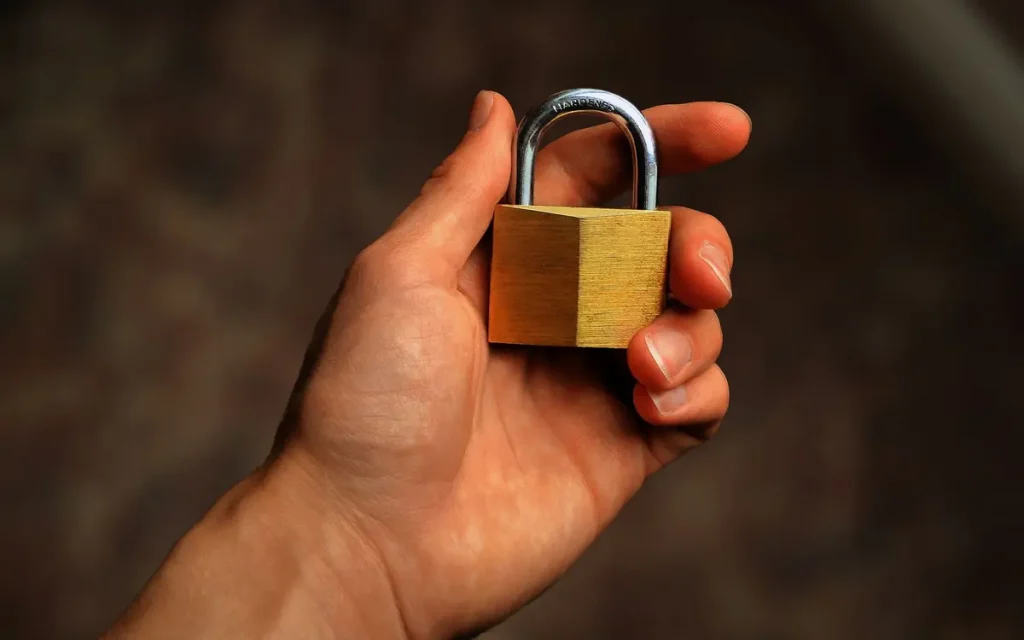 Hand holding a brass padlock, lock service in Powdersville, SC