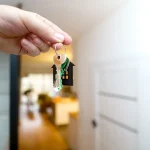 Hand holding house keys, rekey locks in Anderson, SC